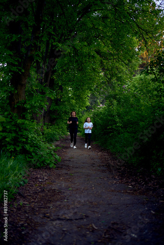Wallpaper Mural mother and daughter run together along a green alley Torontodigital.ca
