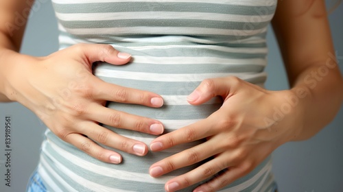 Wallpaper Mural a pregnant woman holding her stomach with both hands Torontodigital.ca