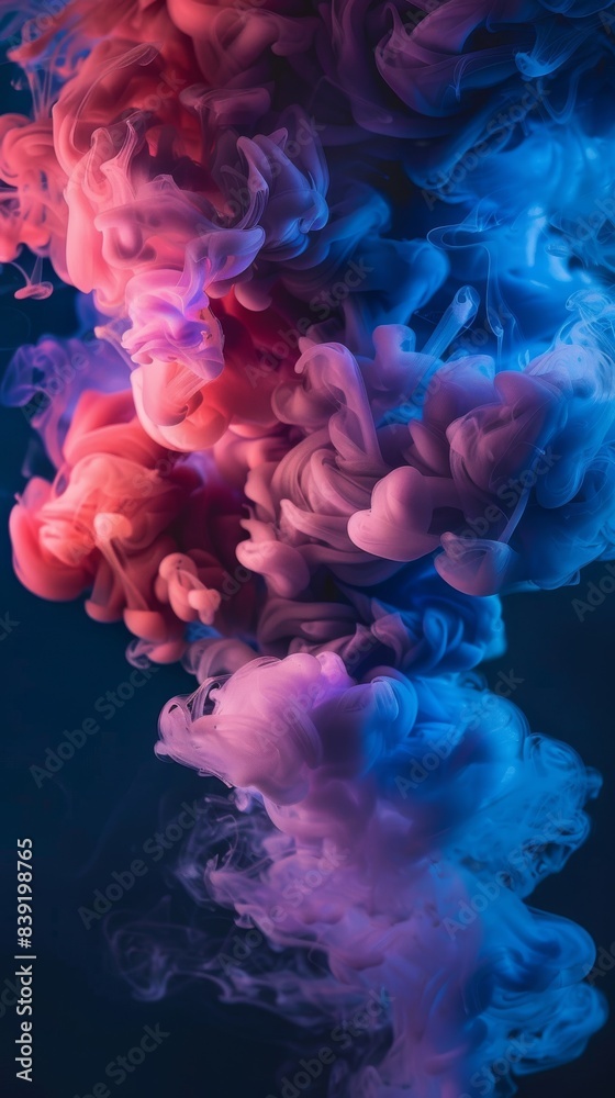 Obraz premium Close up of pink and blue ink smoke in water, on a black background, in the style of hyper realistic photography