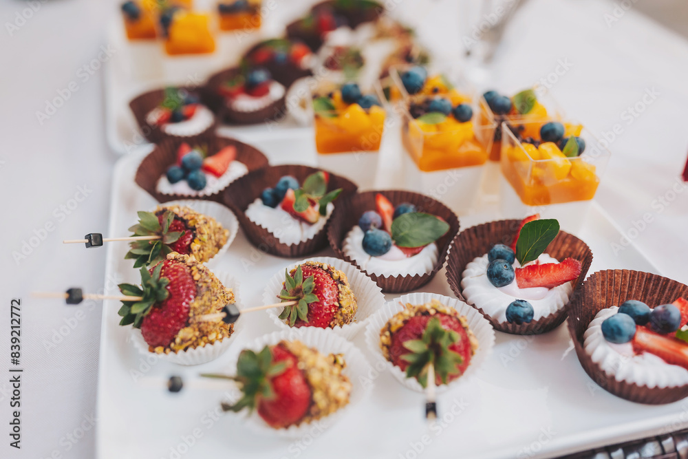 Candy Bar. Delicious sweet buffet. Sweet holiday buffet with cupcakes, strawberries and other desserts with fruits and berries.Table with sweets, candies, dessert.