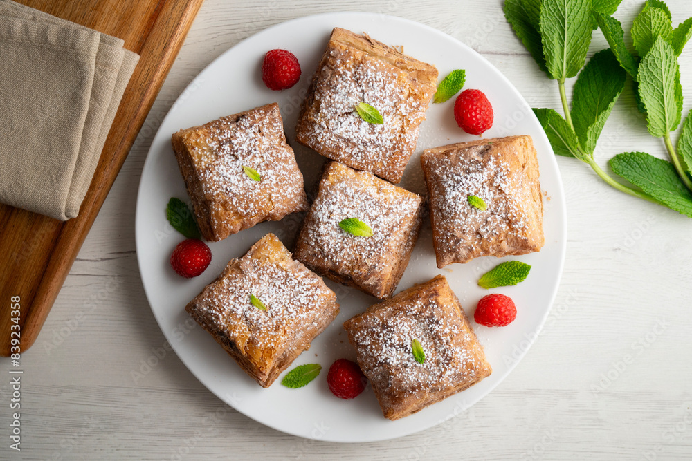 Miguelitos are typical pastries from Spain made from puff pastry, filled with chocolate cream and sprinkled with sugar. Miguelitos are typical pastries from Spain made from puff pastry, filled with chocolate cream and sprinkled with sugar.