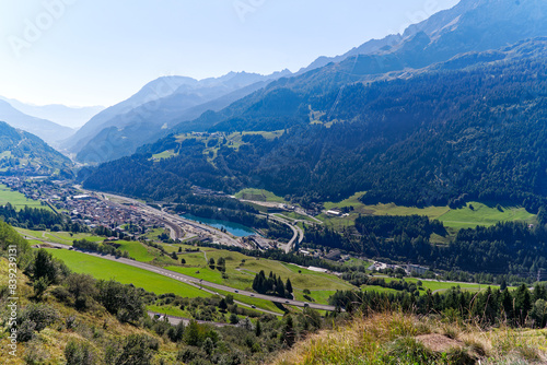 Fotografie Scenic aerial view of mountain village Airolo with Leventina Valley in the Swiss Alps on a sunny late summer day