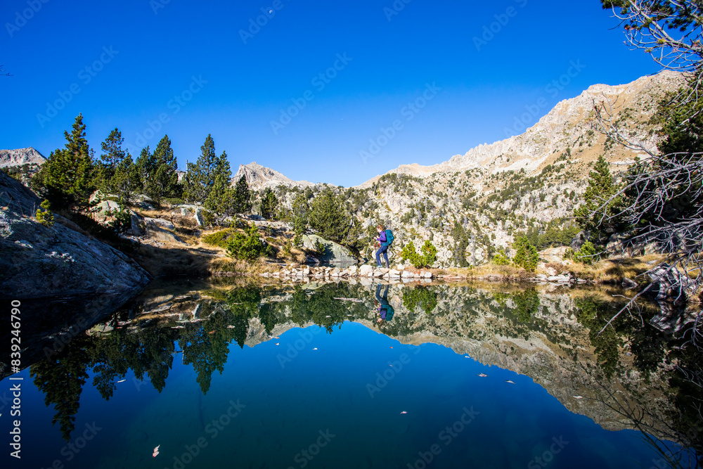 Young hiker woman in autumn in Aiguestortes and Sant Maurici National Park, Spain Young hiker woman in autumn in Aiguestortes and Sant Maurici National Park, Spain