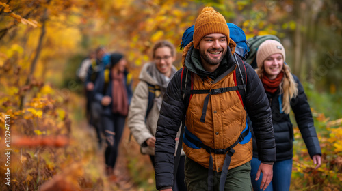 A group of friends hiking during the fall  enjoying the cool weather and vibrant leaves  with laughter and fun along the trail.