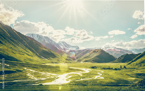 Dramatic panoramic landscape view of the mountains, river and cloudy sky with sun flare in the sky. Truso valley. Kazbegi. Travel in Georgia photo