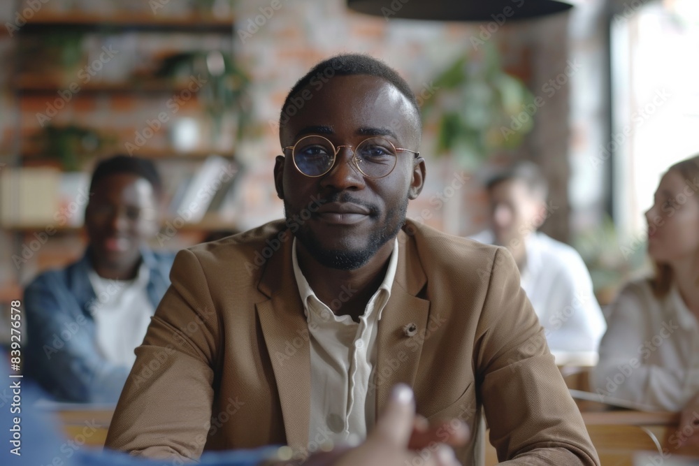 Fototapeta premium Man seated among diverse group