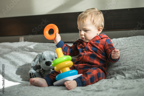 Surprised boy with pyramid and toys  in his hands photo