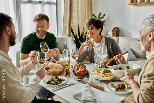 A gay couple shares a meal with parents in a cozy home setting.