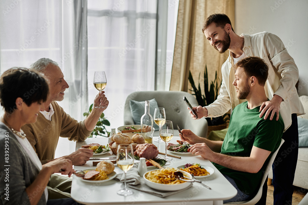 A gay couple introduces their partners to parents during a home-cooked meal. A gay couple introduces their partners to parents during a home-cooked meal.
