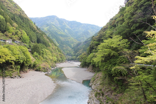 A beautiful view of the jungle and river surrounding the Kitayama River in the Wakayama prefecture of Japan.  Beautiful landscape. photo