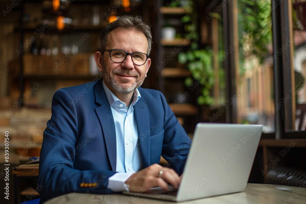 Successful Middle-Aged Businessman Working on Laptop in Office - Confident CEO Portrait in Blue Suit Jacket | 8k Real Photo Successful Middle-Aged Businessman Working on Laptop in Office - Confident CEO Portrait in Blue Suit Jacket | 8k Real Photo