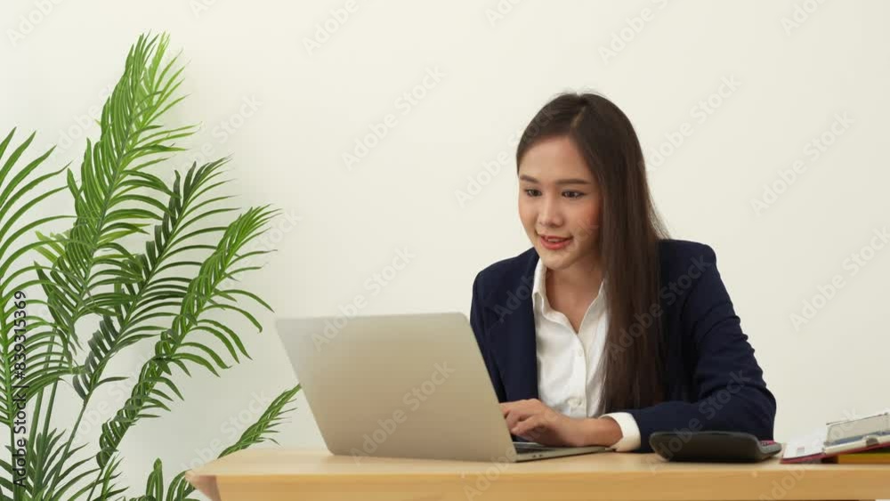 Portrait of smiling beautiful business asian woman at modern office desk using laptop to work and write notes, Business people employee freelance online marketing e-commerce telemarketing concept. Portrait of smiling beautiful business asian woman at modern office desk using laptop to work and write notes, Business people employee freelance online marketing e-commerce telemarketing concept.