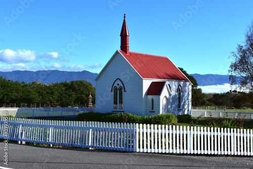 Small church surrounded by a white fence