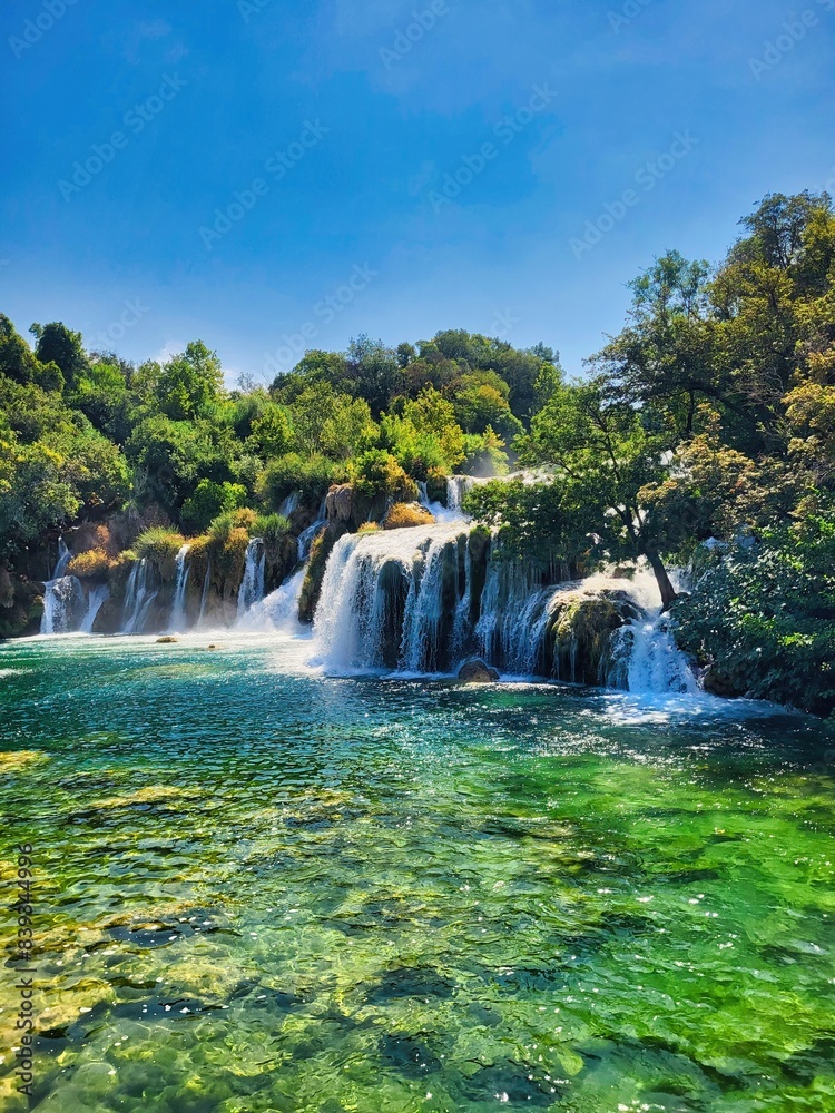 Obraz premium Waterfall and water park. Waterfalls in national park. Nice nature and landscape at the popular tourist attraction. It's known for a series of 7 waterfalls. Plitvice lakes national park