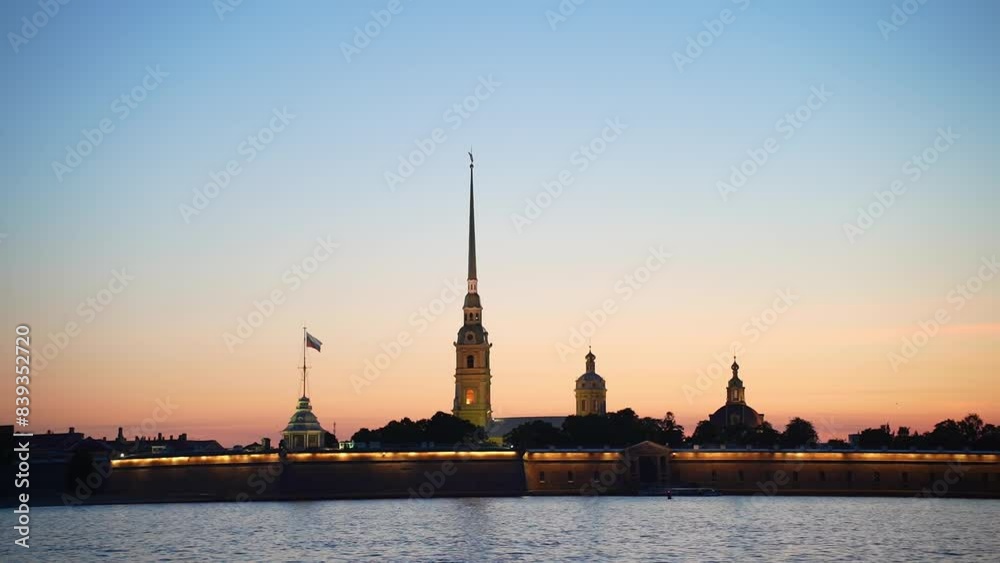 View of the Peter-Pavel's Fortress across the Neva River at white nights. Peter-Pavel's Fortress Evening City Saint-Petersburg, Russia. tourist sight View of the Peter-Pavel's Fortress across the Neva River at white nights. Peter-Pavel's Fortress Evening City Saint-Petersburg, Russia. tourist sight