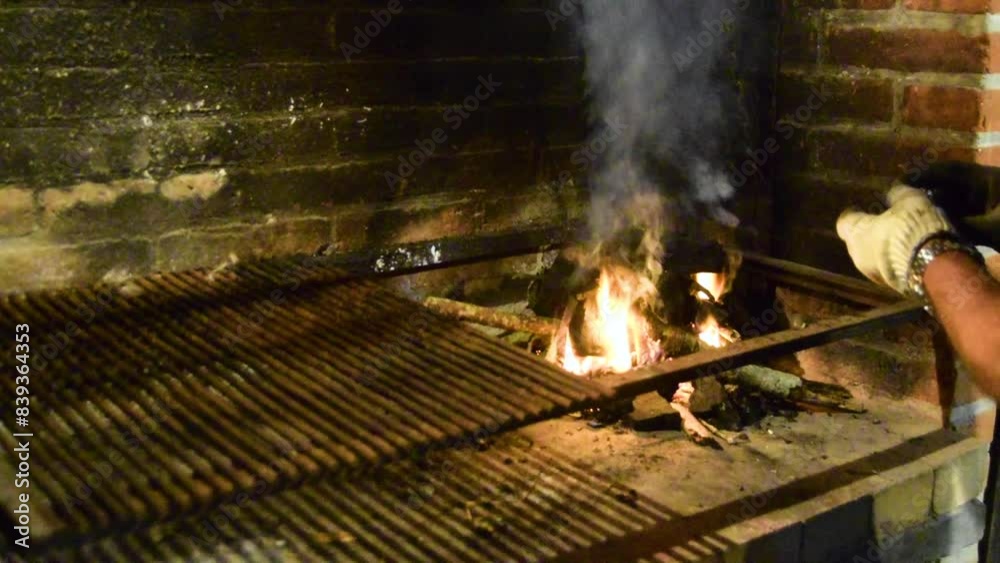Man cooking meat on a barbecue a summer night Man cooking meat on a barbecue a summer night