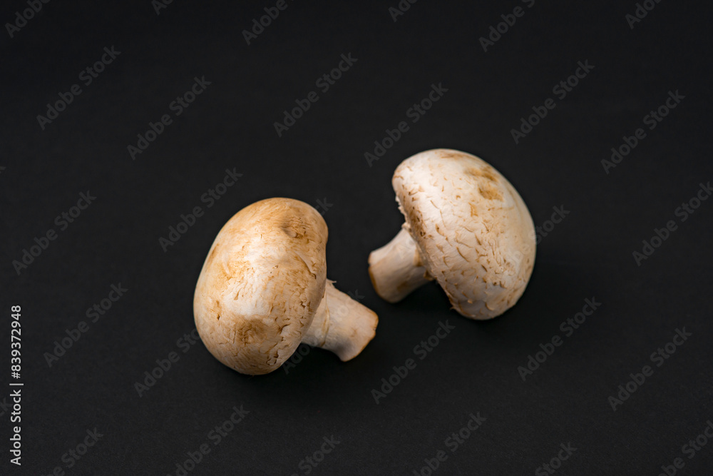fresh champignons mushrooms on black background fresh champignons mushrooms on black background