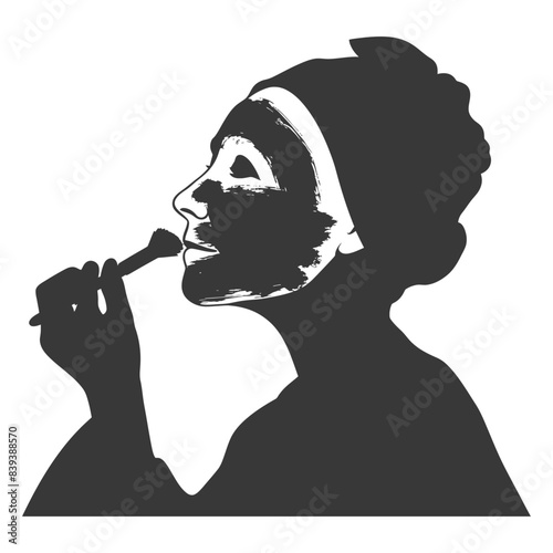 Silhouette: Woman applying clay face mask with brush, beauty routine, spa treatment.