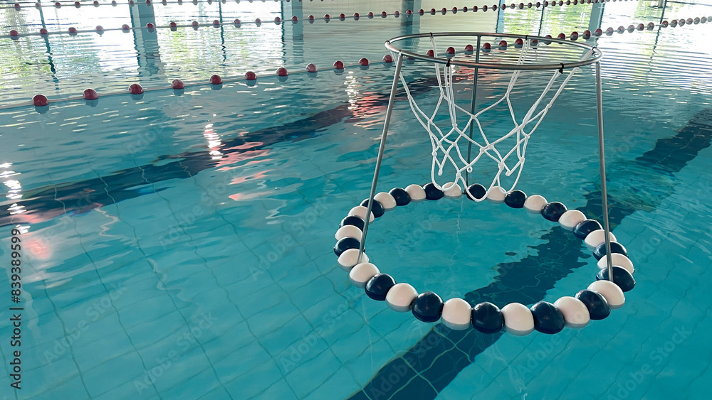 Obraz premium Equipment for water sports and training. A ring for playing water soccer on the surface of the water in the swimming pool. Equipment for water sports and training.