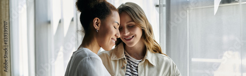 A lesbian couple shares a tender moment indoors, showcasing their love and connection.