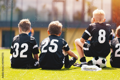 Boys in Football Team. Children Play Match in Youth Soccer League. Friends Have Fun Playing Outdoor Football Tournament. School Sports Team Members in Black Soccer Jersey Shirts With White Numbers