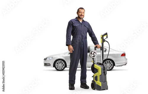 Car wash worker in a uniform with a high pressure washer machine