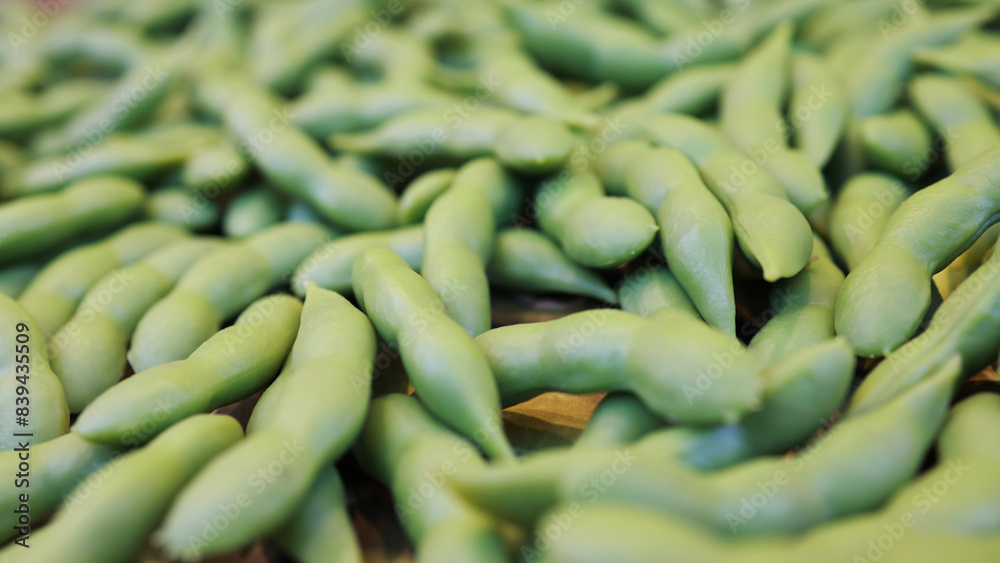 Many green edamame beans in pods as background, closeup,boiled green soybeans, Japanese beans Many green edamame beans in pods as background, closeup,boiled green soybeans, Japanese beans