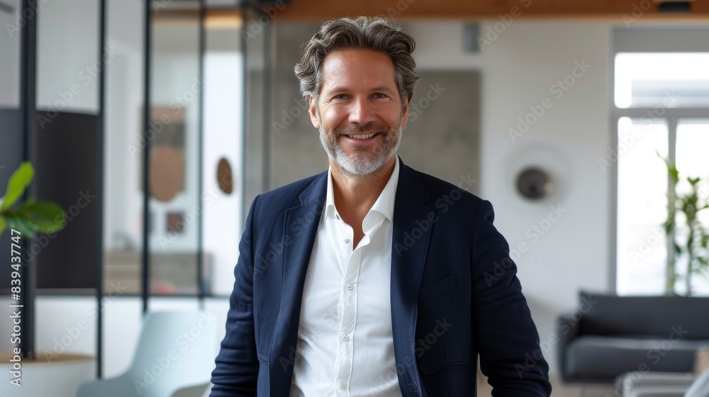 Happy mid aged businessman in a sleek office environment Happy mid aged businessman in a sleek office environment