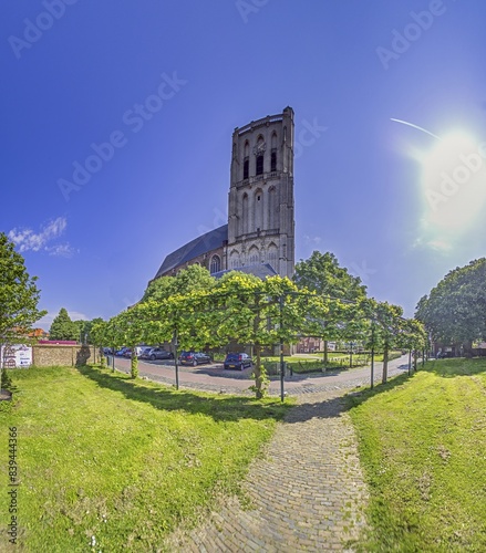 Picture of the cathedral of Brielle in Holland with bell tower in front of a blue sky photo