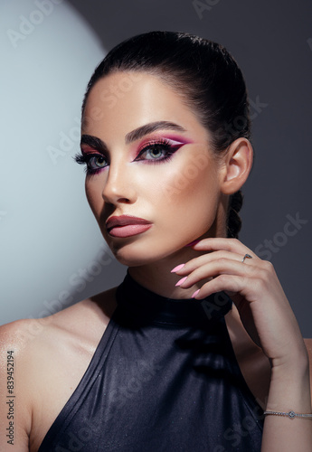 Beautiful woman with amazing makeup  closeup portrait on dark background. 