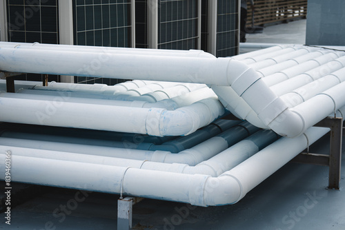 The air conditioner refrigerant pipe system is covered with PVC pipe and painted.