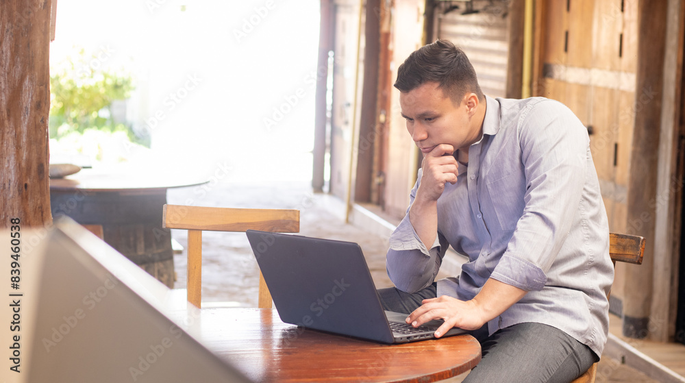 freelance latin young man with his laptop working. executive concept,remote work freelance latin young man with his laptop working. executive concept,remote work