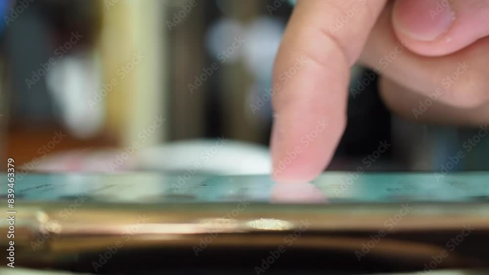 Male index finger scrolling through phone screen close up view. Internet and digital lifestyle. Side view.