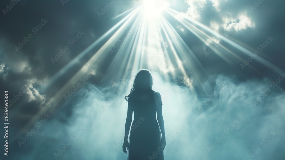 Silhouette of a woman standing in fog, illuminated by rays of light breaking through clouds, evoking mystery and awe. Silhouette of a woman standing in fog, illuminated by rays of light breaking through clouds, evoking mystery and awe.