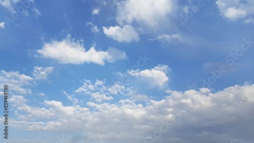 Above, the azure expanse is decorated with fluffy cumulus clouds, fashioning a picturesque natural vista.