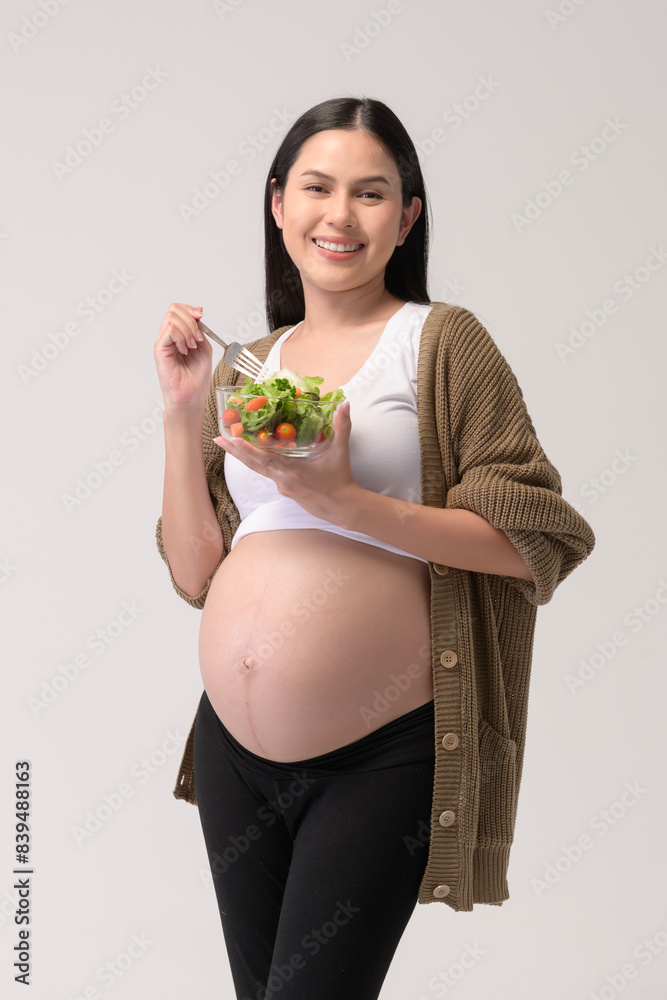 Portrait of Beautiful pregnant woman eating salad over white background studio, health and maternity concept. Portrait of Beautiful pregnant woman eating salad over white background studio, health and maternity concept.