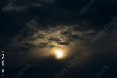 Sunset against the backdrop of dark rain clouds. © APHOTOSTUDIO