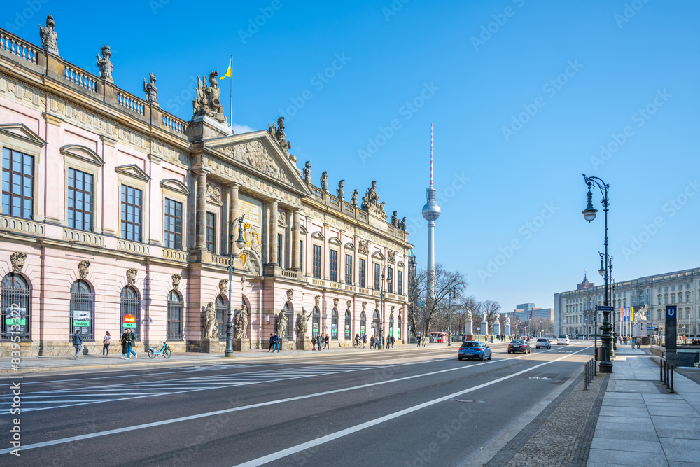 Fototapeta premium Clear blue skies over the German Historical Museum, with people walking outside and featuring the iconic Television Tower, Berlin, Germany