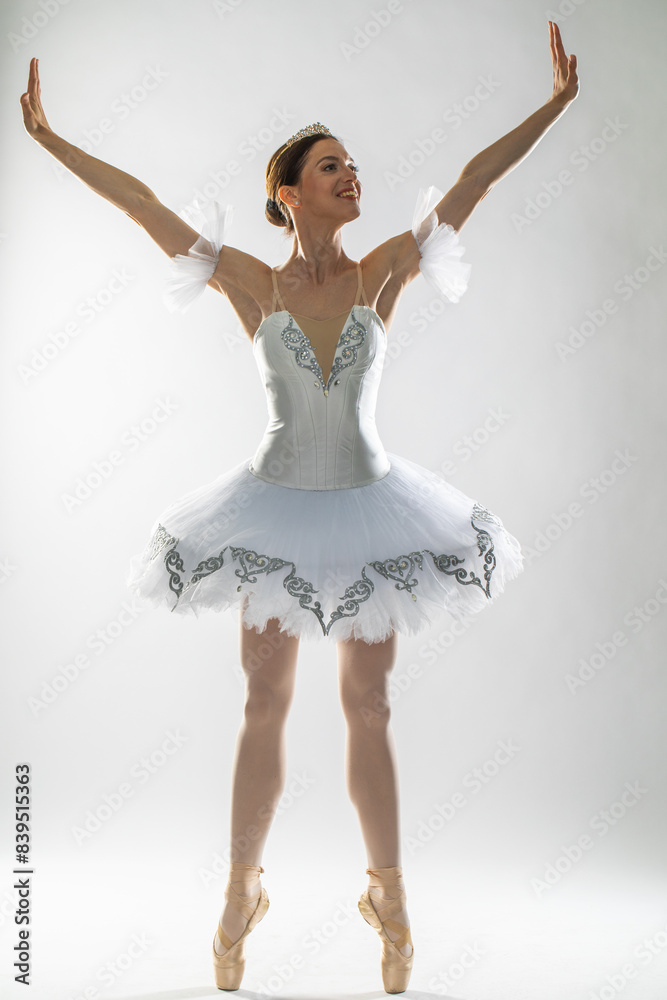 Naklejka premium Full length portrait of an adult female ballerina in a white tutu