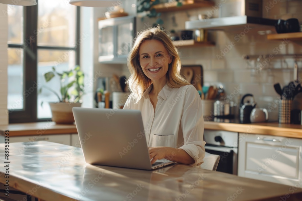 Woman working on laptop computer in home office Woman working on laptop computer in home office