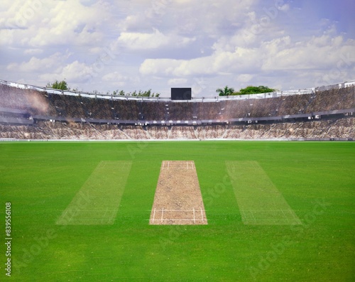A cricket pitch direct top view of the layout with the grass cricket field. The pitch is inside the field and green field, Cricket match between two teams.