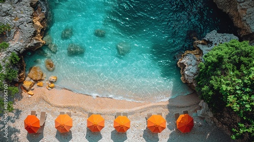 Fototapeta Naklejka Na Ścianę i Meble -  Aerial view of yellow and blue umbrellas on empty sandy beach, blue sea at sunset in summer