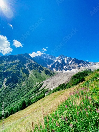 The Seven Glacier in the Elbrus Mountains. Valleys, green meadows, snowy ridges and a valley with a mountain lake