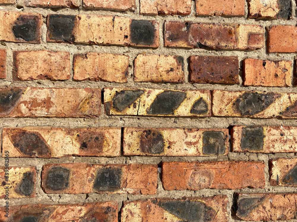 brick wall with an array of bricks in various shades of red and brown