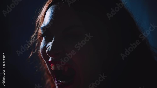 art portrait mouth close-up fantasy vampire person screams growls hisses shows sharp white teeth fangs lips beauty part face gothic woman in moon light night smoke fog dark room sexy girl werewolf 4k photo