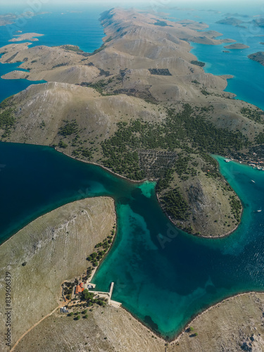 Drone aerial view of Kornati archipelago in Croatia, yacht pier and beachfront vacation homes photo