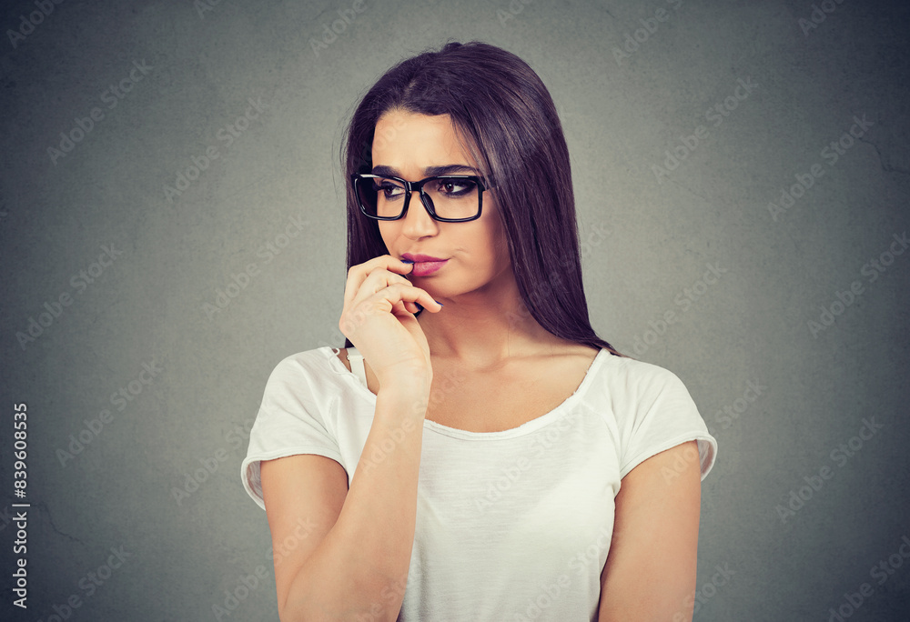 Preoccupied young woman in glasses overthinking Preoccupied young woman in glasses overthinking