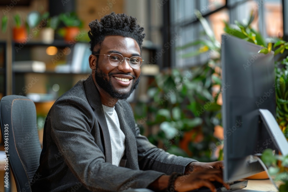 Man glasses desk computer smiling