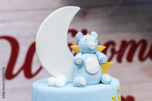 Close-up of a cute, handcrafted teddy bear and moon cake decoration for a baby shower or birthday