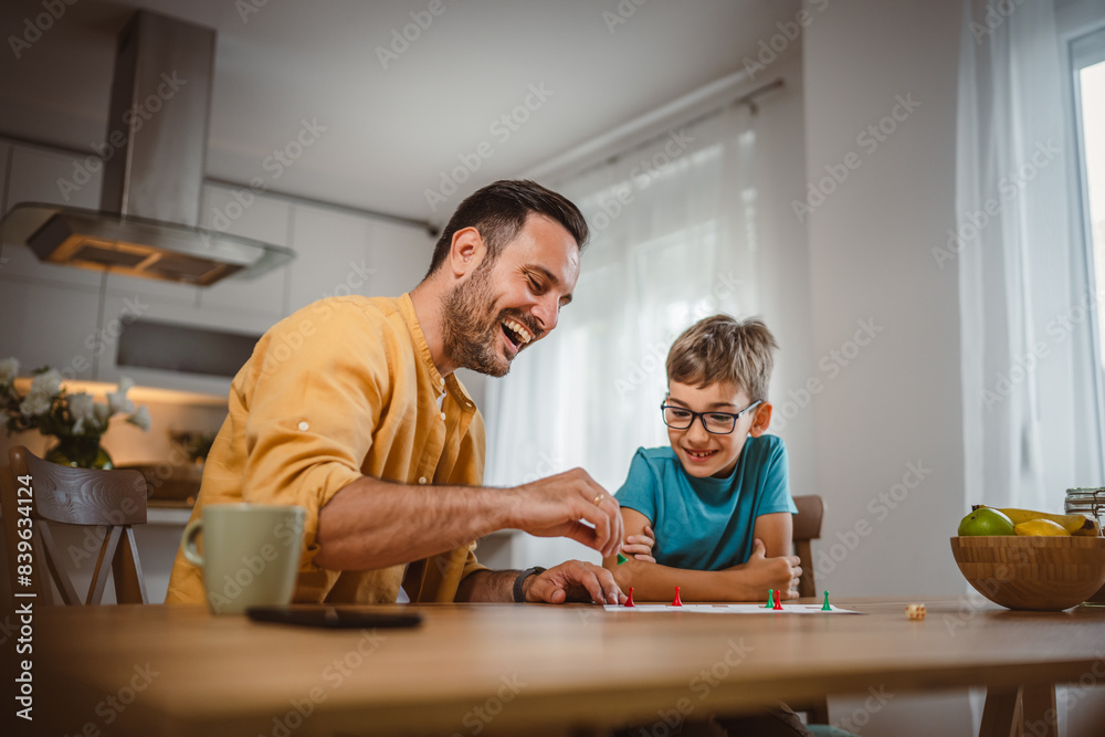 Father and son play board game have fun together at home Father and son play board game have fun together at home